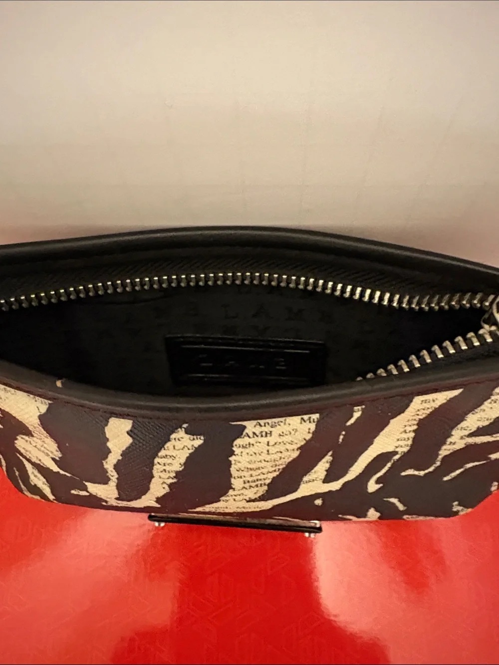 L.A.M.B. Black and Cream Zebra-Print Clutch with Logo Plate